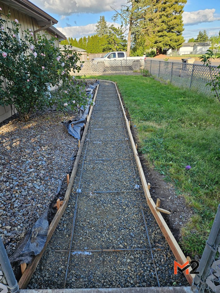 Before: Concrete sidewalk installation with curved forms and reinforced base preparation for new residential backyard flatwork project.