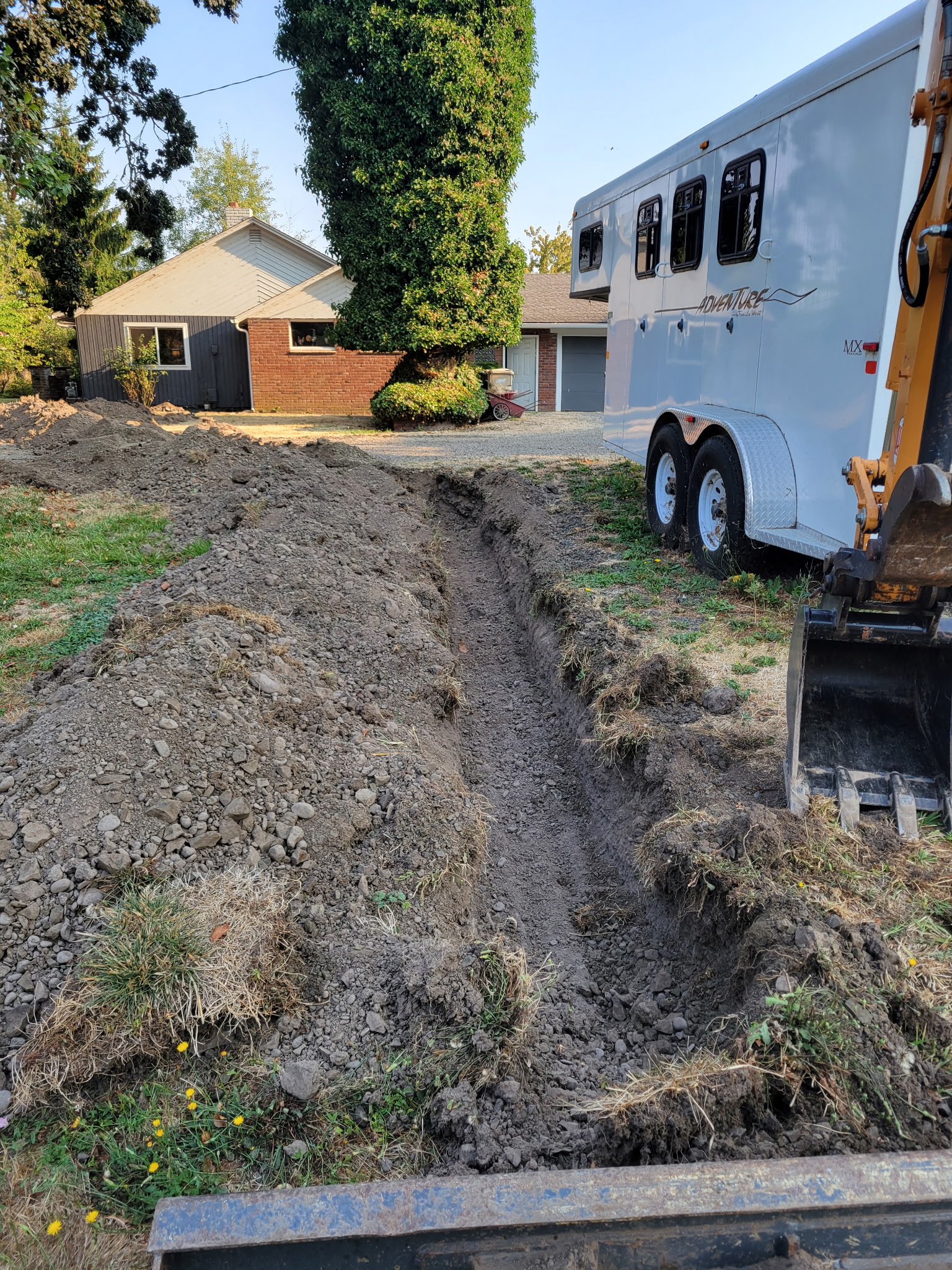 Mini excavator performing trenching work in Linn County Oregon
